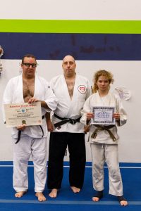 Sensei Karl Mueller with promotees Kevin and Kira